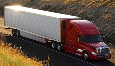 Semi truck driving down highway.