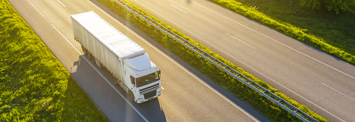 Heavy duty truck driving on highway.