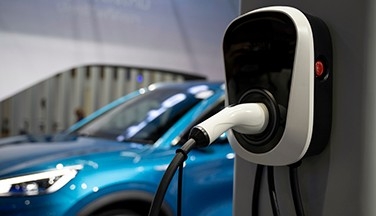 Electric car plugged into outlet charging.