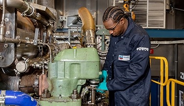 Man working on test engine in laboratory